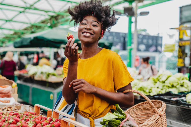 young african woman buying fruits at the market